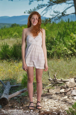 18 year old girl Megan Rain removes her sandals and then clothes to pose naked